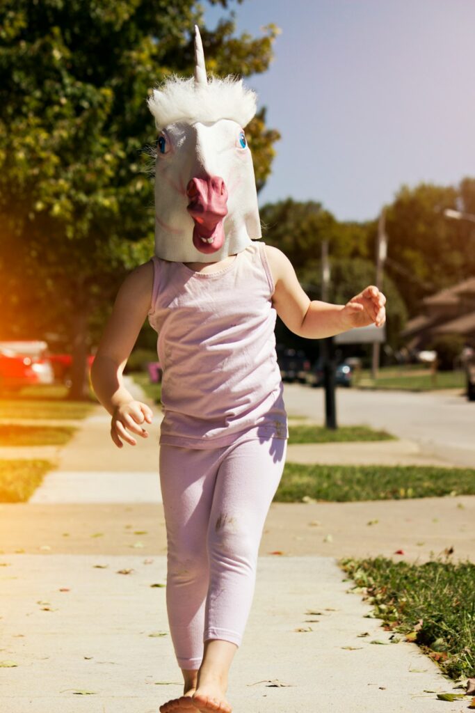 person wearing unicorn hat while walking outside